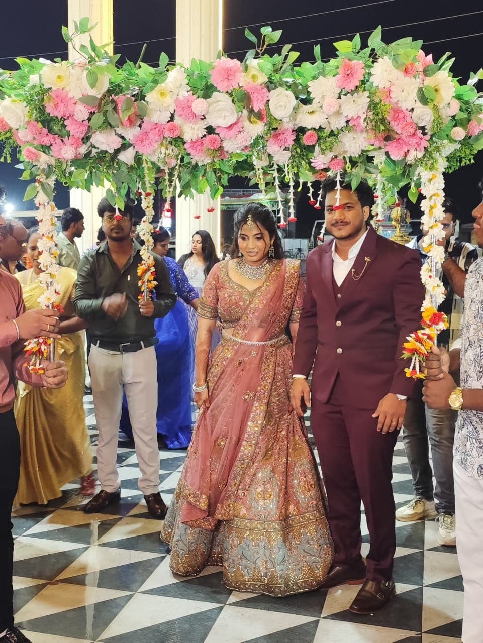 A Glamroyal couple under a floral wedding mandap